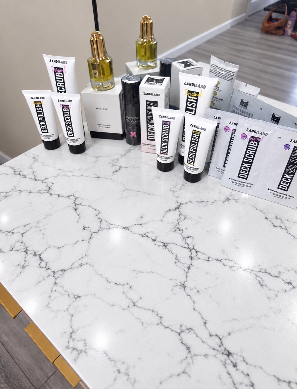 Queen of Hearts Wax Studio post-wax care products displayed on a marble counter