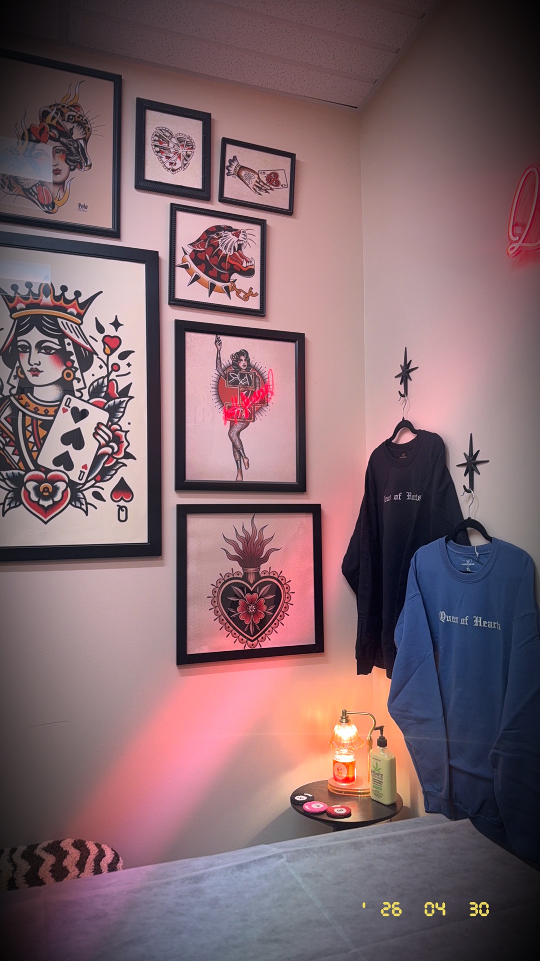 Queen of Hearts Wax Studio merch corner and framed art